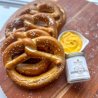 Handcrafted Milwaukee Candle Company scented candle, five 5 oz pretzel twists and nacho cheese in a serving dish on table