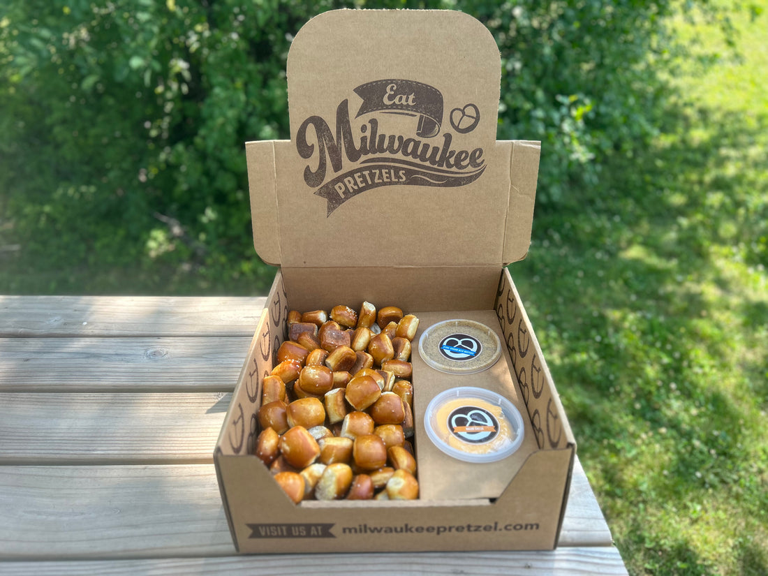 One Hundred (100) pretzel bites salted and ready to eat in a catering box with 2 different dips